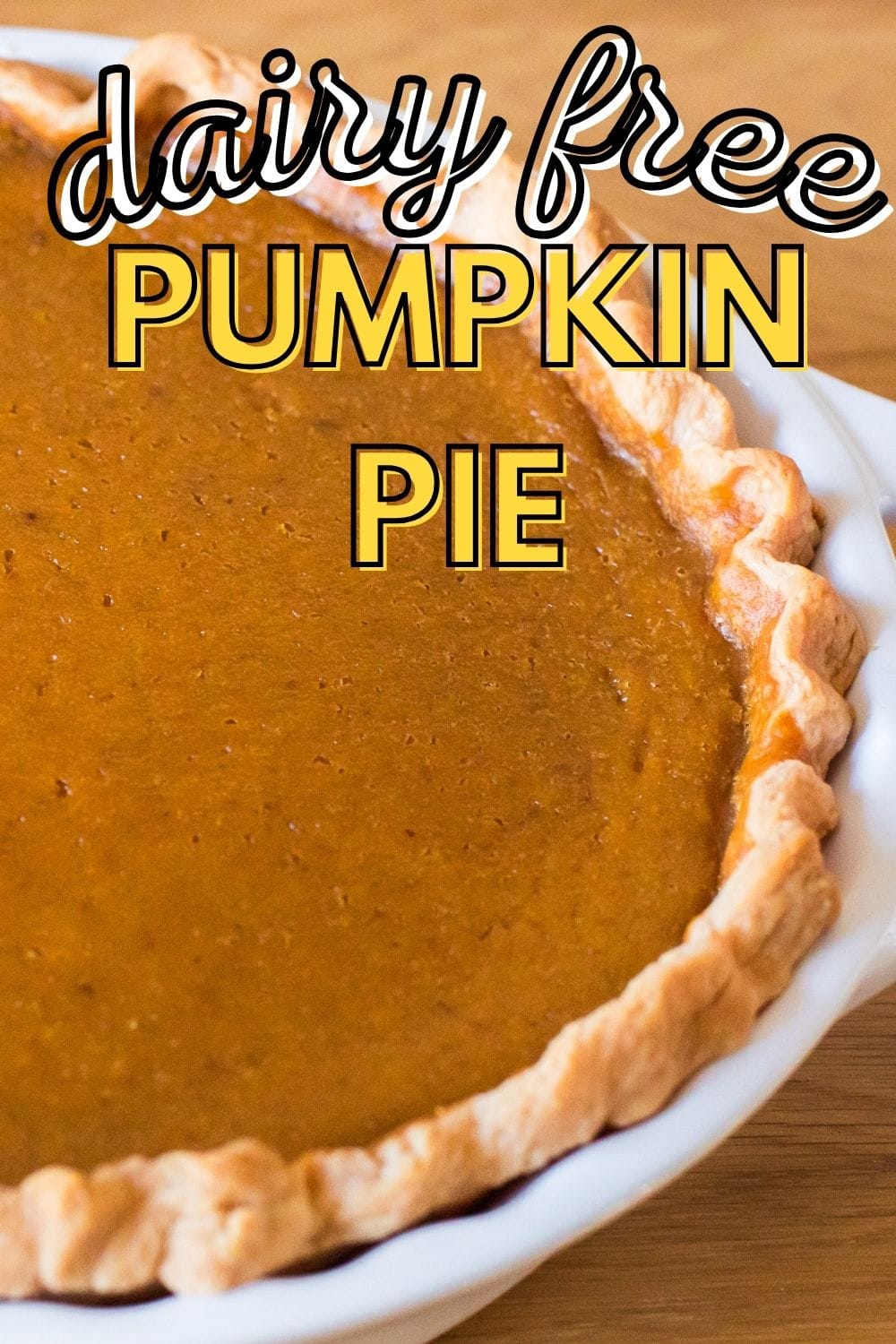 dairy free pumpkin pie in a pie plate with text on image for pinterest.