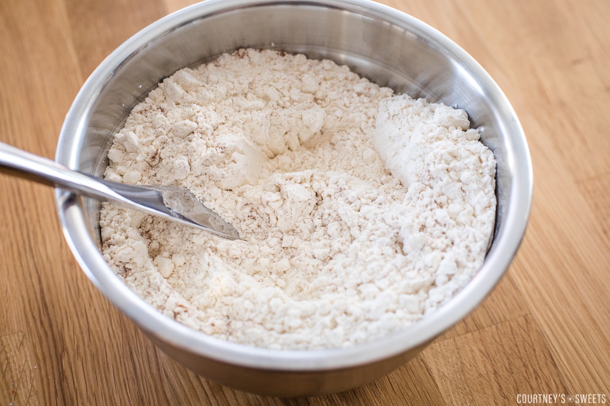 dry ingredients in a mixing bowl with a butter knife in it