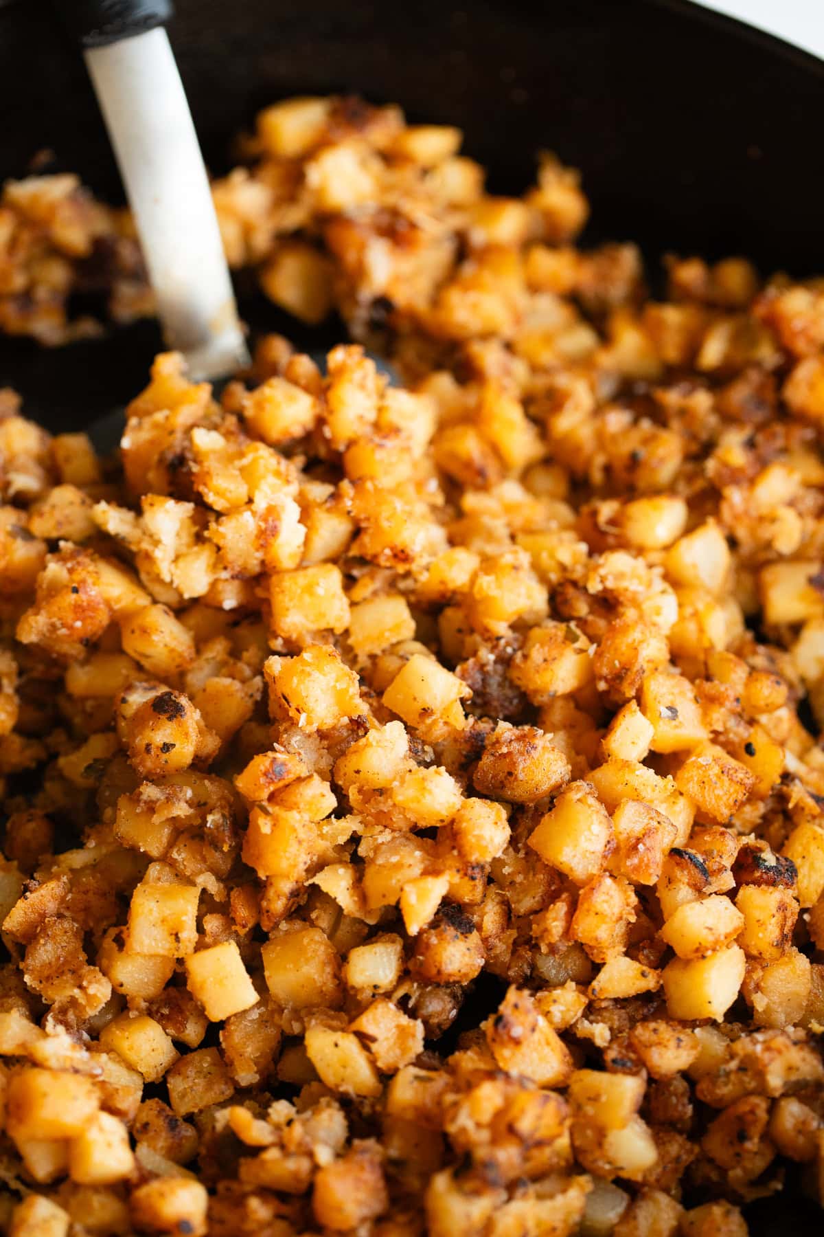 home fries in a cast iron skillet on a spatula too.