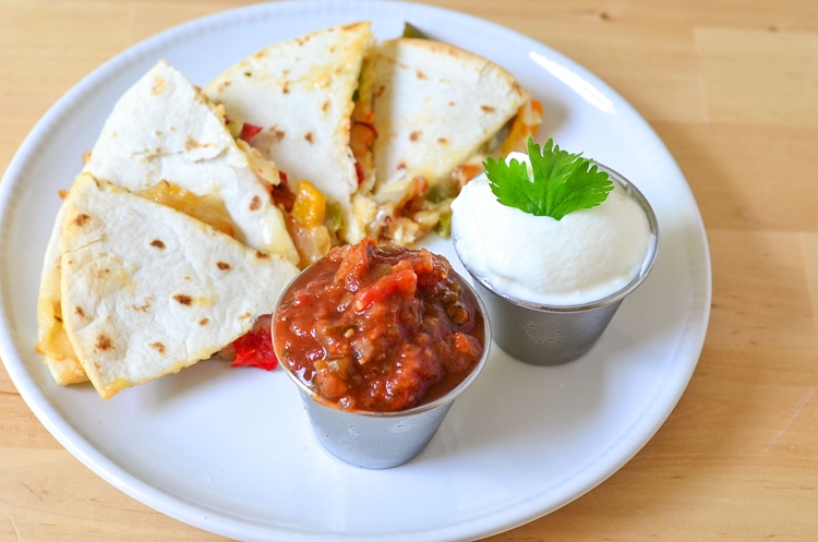 Chicken Quesadillas Recipe - Super easy restaurant style quesadillas made at home. We bake them in the oven to make them a bit of a healthier option, no frying in a pan! Kid friendly recipe on Mini Chef Mondays