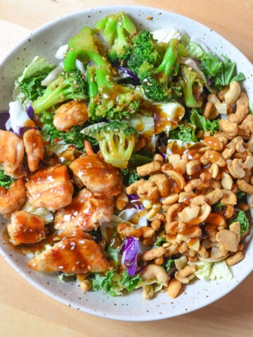 Asian Sesame Chicken Salad - a quick healthy a simple recipe for the entire family to enjoy. Filling meal and full of nuts, chicken, broccoli and beautiful, nutritious greens!