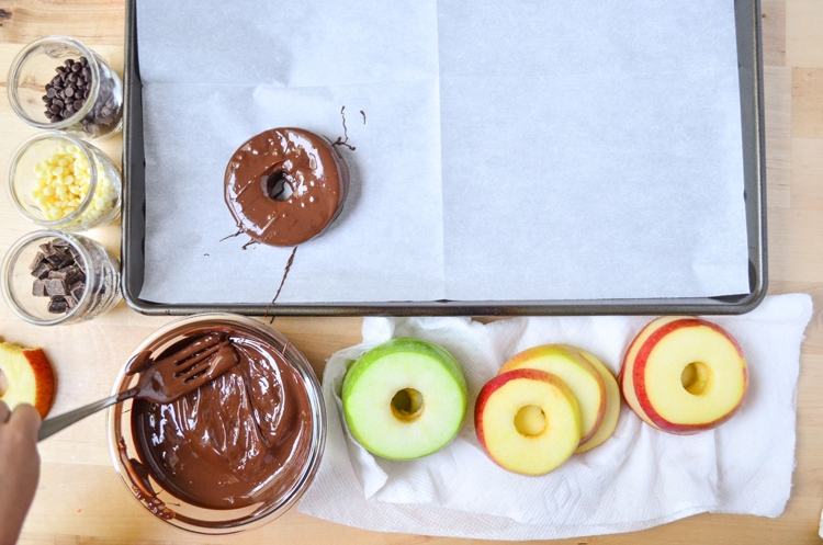 Try our delicious and healthy no bake fall treat; chocolate covered apple donuts! Freshly picked crisp apples that we covered in triple chocolate. It's a fun, healthy snack for the fall season when you pick apples. Serve to guests and wow them for sure, plus it's easy for your mini chef to help make them. :) They're a great vegetarian option so everyone can enjoy. You could even make them raw vegan treats if you choose vegan toppings.