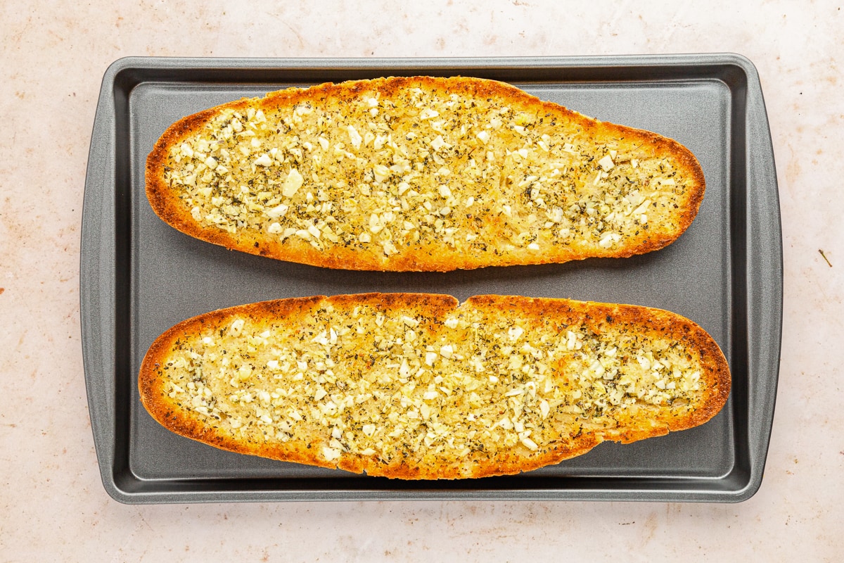 fresh baked garlic bread on baking sheet.