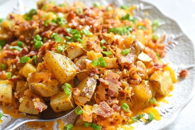 These cheesy bacon potatoes are bound to be the favorite side dish at your holiday table. It's the ultimate comfort food recipe and hello BACON! 