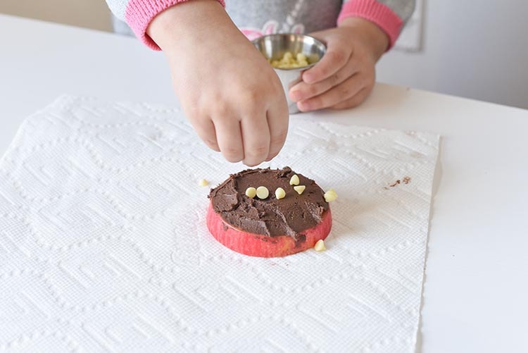 Mini Chef Mondays Easy Apple Donut Recipe for kids! Easy healthy snack using sprinkles for your favorite no bake holiday treats. 