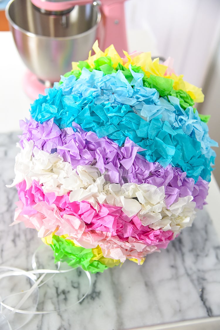 Have fun creating this DIY Pinata Easter Egg for a kid friendly Easter craft with your kids! This is a great DIY home tutorial or even a fun classroom activity.