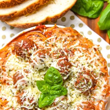 Baked Spaghetti and Meatballs is an easy dinner recipe of Italian Meatballs with Beef and Pork, Homemade Marinara Sauce, Al Dente Pasta, Ricotta Cheese, Mozzarella, Basil, and Parmesan Cheese.