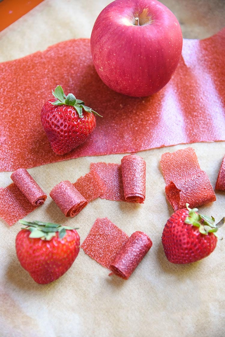 Childhood favorite Homemade Fruit Leather Recipe! Organic applesauce, organic strawberries are all you need for this Strawberry Apple Fruit Leather Recipe.