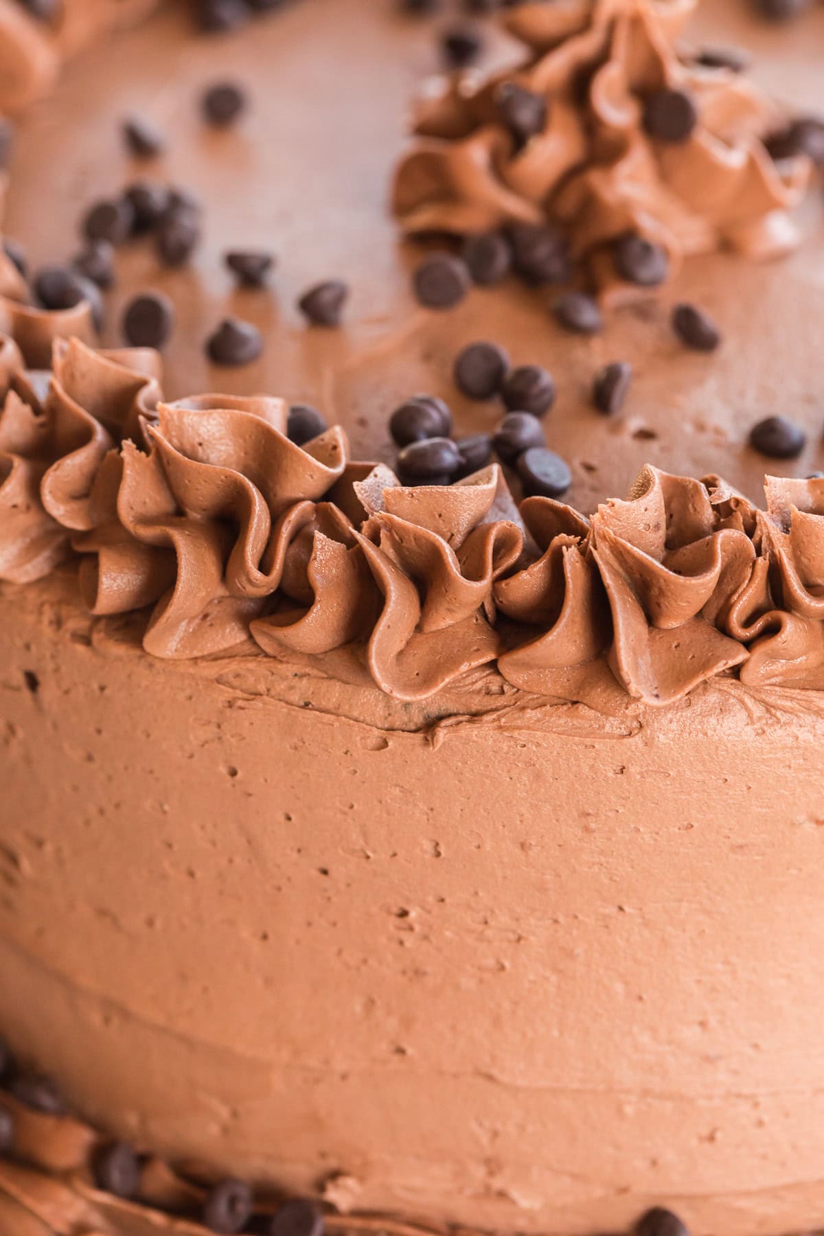 close up of chocolate buttercream on a chocolate layer cake.