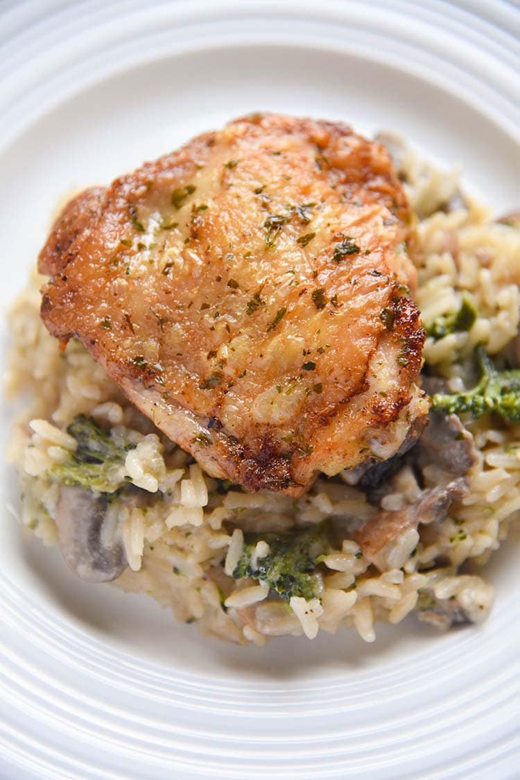 crispy chicken thighs over mushroom broccoli with rice