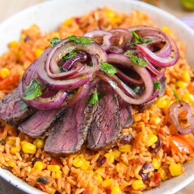 sizzling mexican steak recipe topped with onion relish