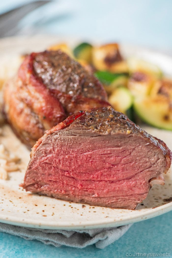 This bacon wrapped filet mignon will wow your dinner guests. Nicely seared on the outside with a beautiful pink inside on this air fryer filet mignon with bacon! how to cook bacon wrapped filet mignon