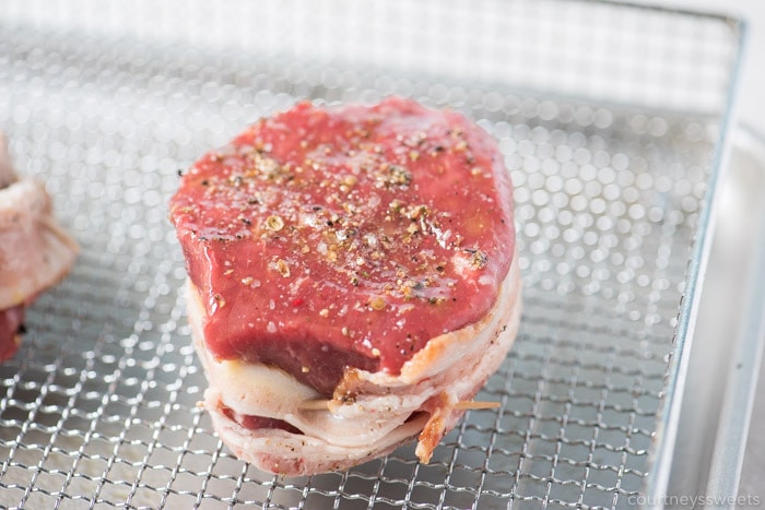 This bacon wrapped filet mignon will wow your dinner guests. Nicely seared on the outside with a beautiful pink inside on this air fryer filet mignon with bacon! ways to cook bacon wrapped filet mignon