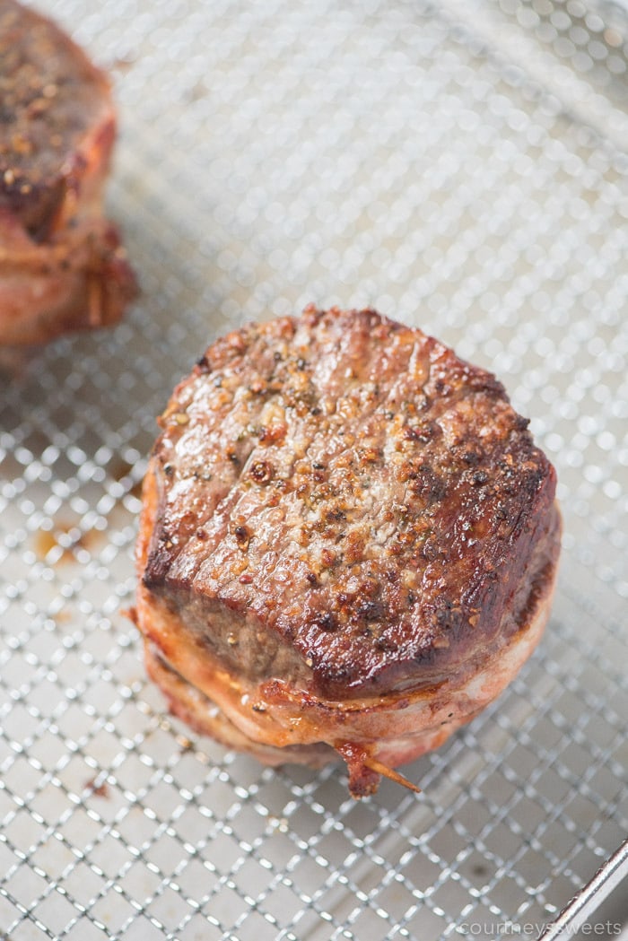 This bacon wrapped filet mignon will wow your dinner guests. Nicely seared on the outside with a beautiful pink inside on this air fryer filet mignon with bacon! air fryer abacon wrapped filet mignon