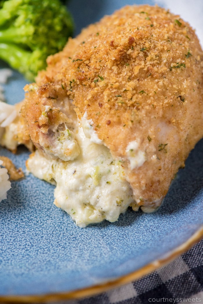 broccoli and cheese stuffed chicken thighs on a plate with broccoli