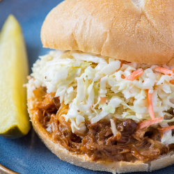 pulled pork sandwiches with coleslaw on a kaiser roll
