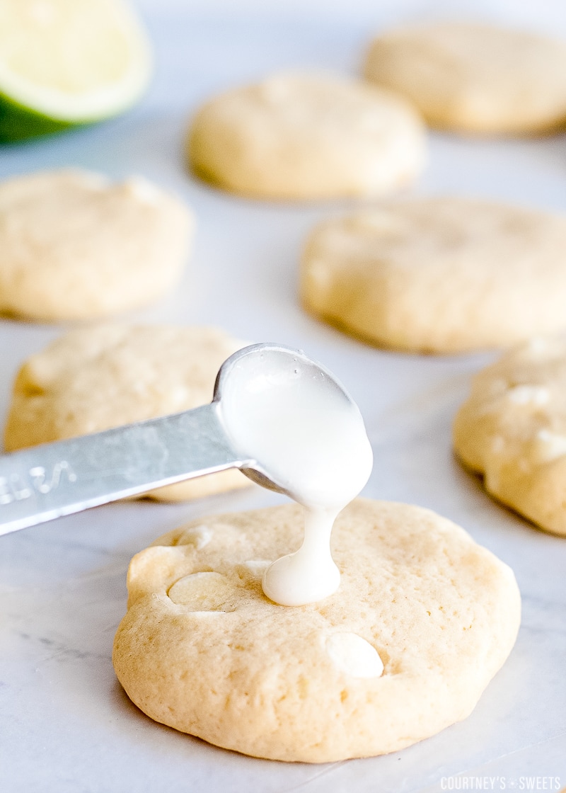 lime glaze in a spoon covering key lime cookies