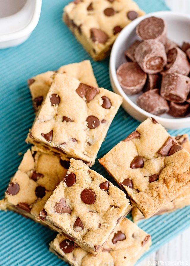 overhead photo of chocolate chip cookie bars on a teal napkin