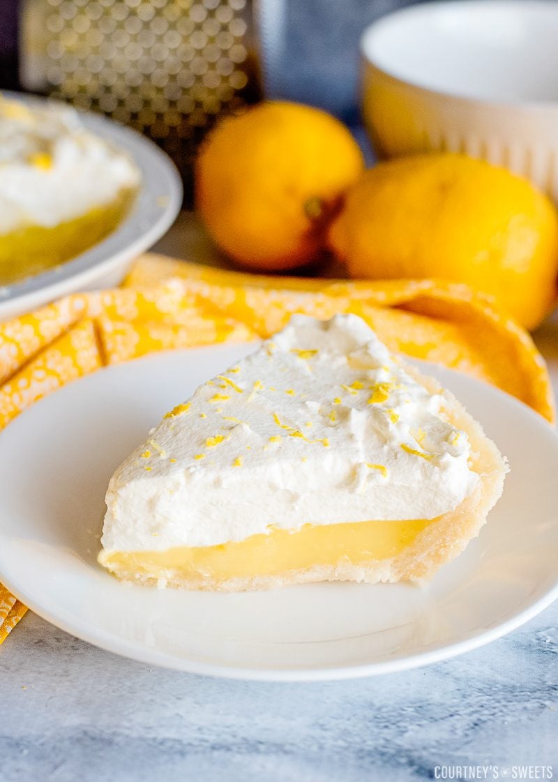 lemon pie on a plate with homemade whipped cream topping