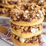 stacked smores donuts on a baking rack