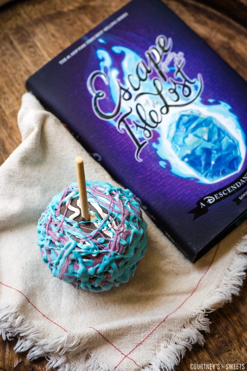 how to make Chocolate Covered Apples Inspired by Disney Descendants decorated chocolate covered apple on a towel with book