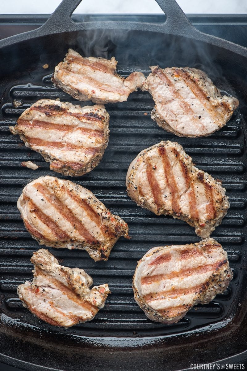 grilled pork loin medallions on a grill pan with smoke