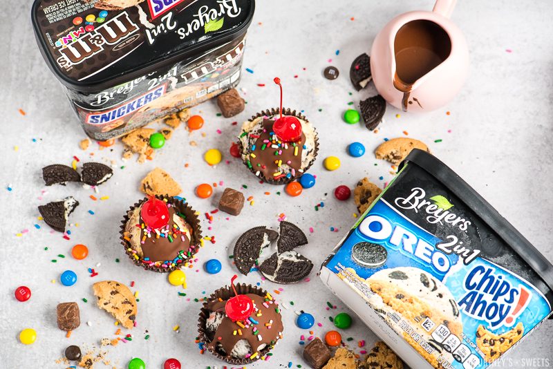 8 breyers 2 in 1 ice cream with ice cream cupcakes and candy and cookies scattered around