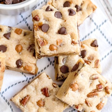 salted caramel chocolate chip cookies bars with pecans on a napkin