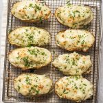 air fryer baked potatoes stuffed with mozzarella cheese on air fryer rack on towel