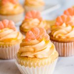 orange buttercream frosting on orange cupcakes