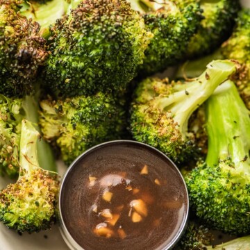 air fryer broccoli in a bowl with chinese garlic sauce in smaller bowl