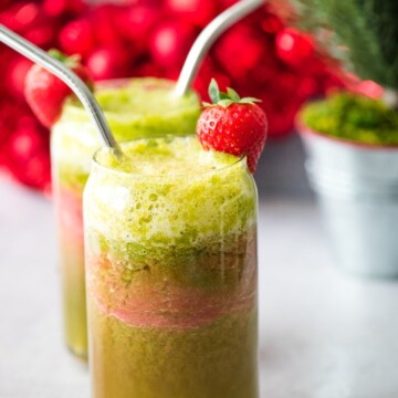 holiday mocktail in glass jar with strawberry and stainless steel straw