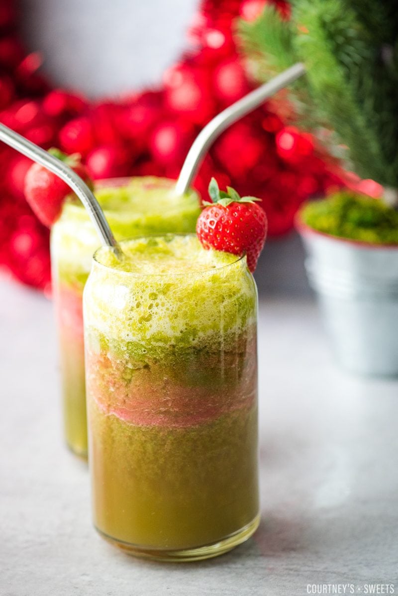 holiday mocktail in glass jar with strawberry and stainless steel straw