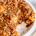 sticky buns in a ceramic dish with one missing