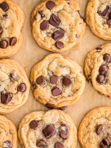 chocolate chip cookies on a parchment lined baking sheet