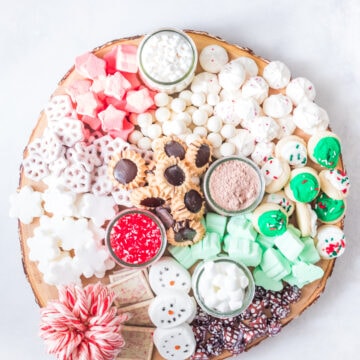 overhead photo of hot chocolate charcuterie board with various sweets and treats