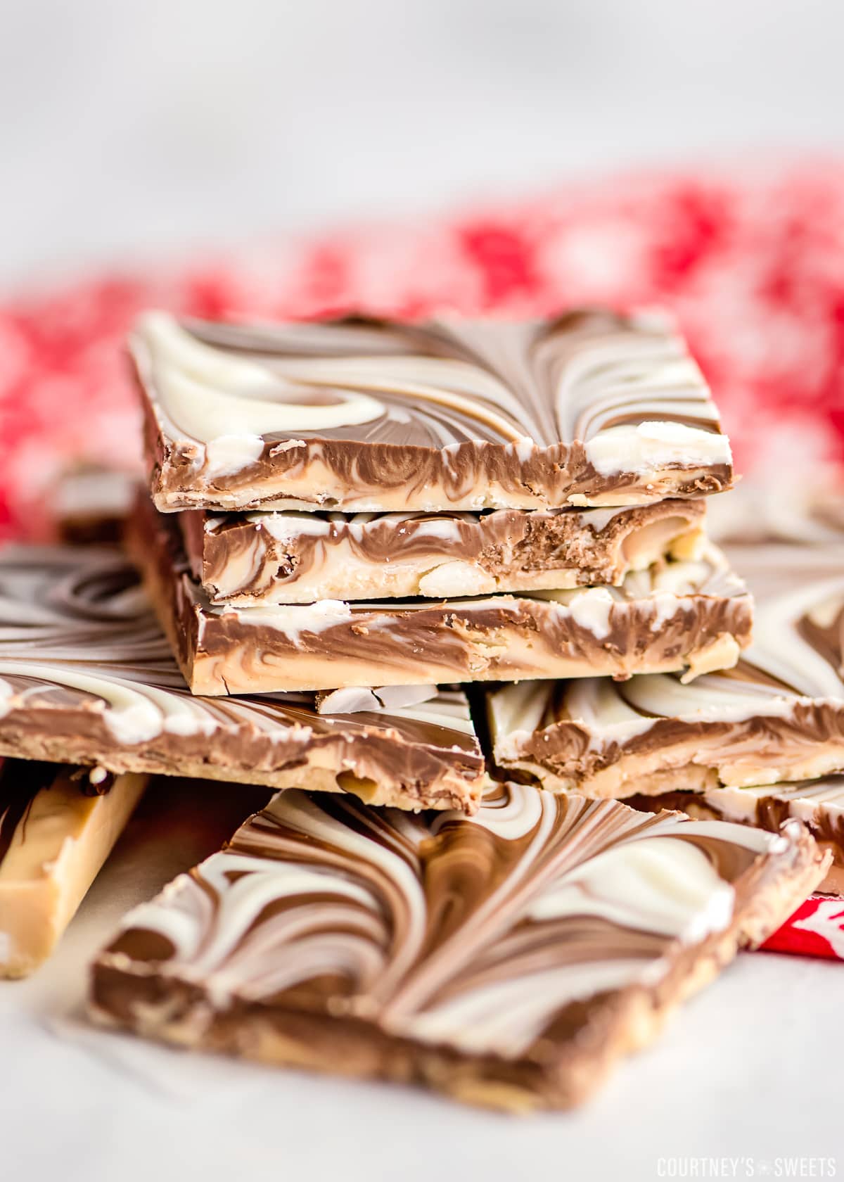 stacked tiger butter on a marble slab with red and white decorative napkin under it