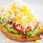 grated egg avocado toast on a neutral colored plate.