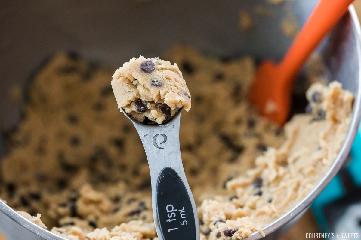 cookie dough in teaspoon measuring spoon.