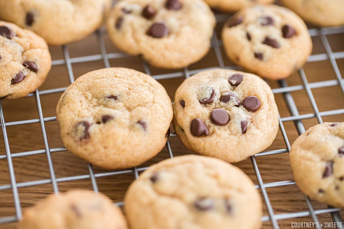 comparison of cookie without added chocolate chips before baking next to one with added chocolate chips to top before baking.