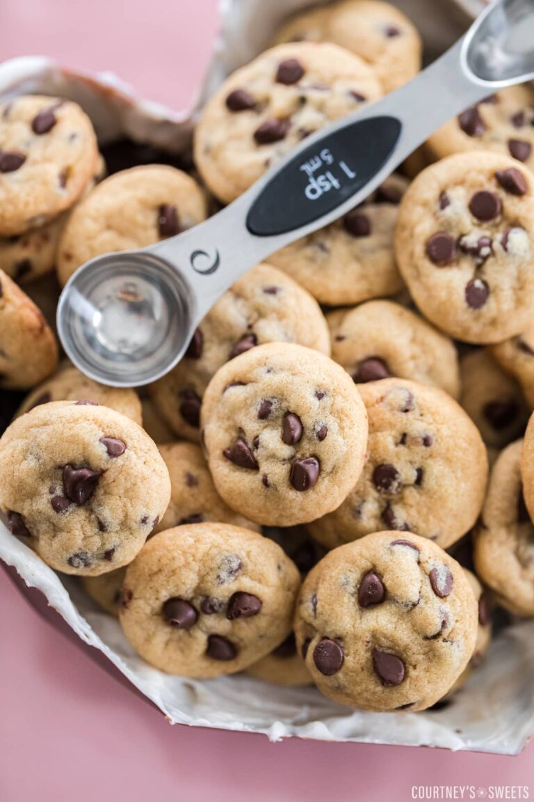 mini chocolate chip cookies in a chocolate molded heart with a teaspoon measuring spoon to show size on top.