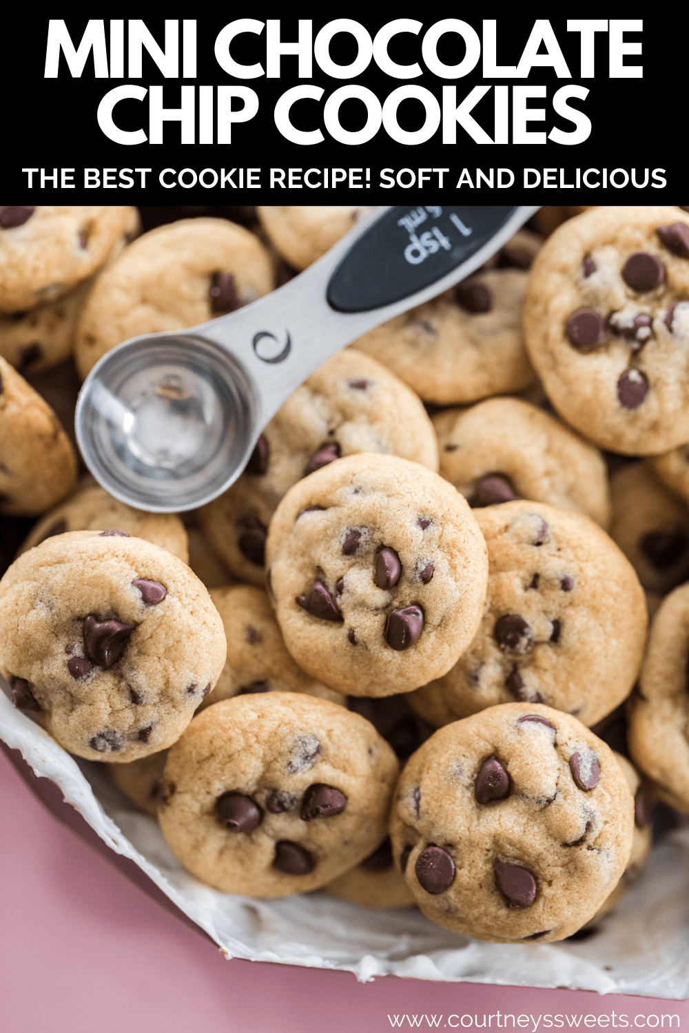 mini chocolate chip cookies in a chocolate molded heart with a teaspoon measuring spoon to show size on top of the cookies with text pinterest image