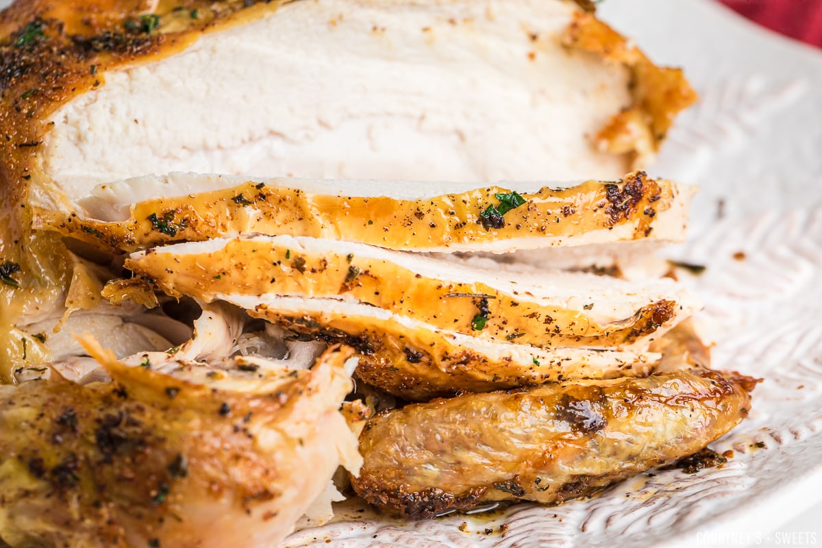 close up of air fryer chicken with breast sliced.