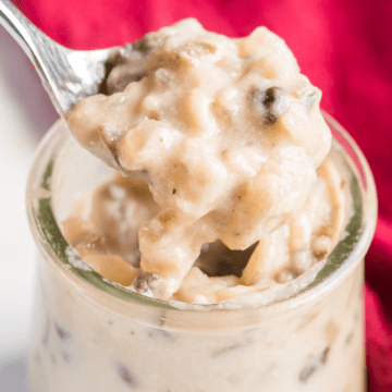 condensed cream of mushroom soup in a glass jar with a spoon scooping it out.