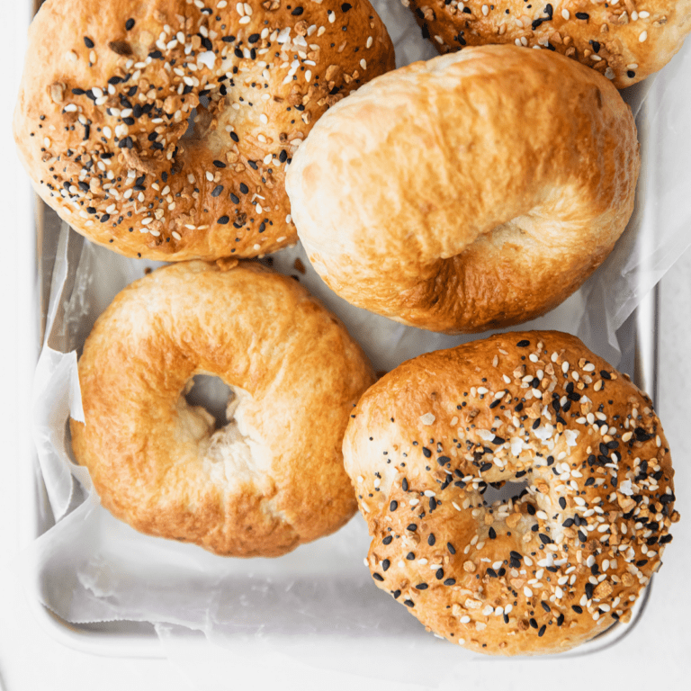 air fryer bagels on a parchment lined pan.