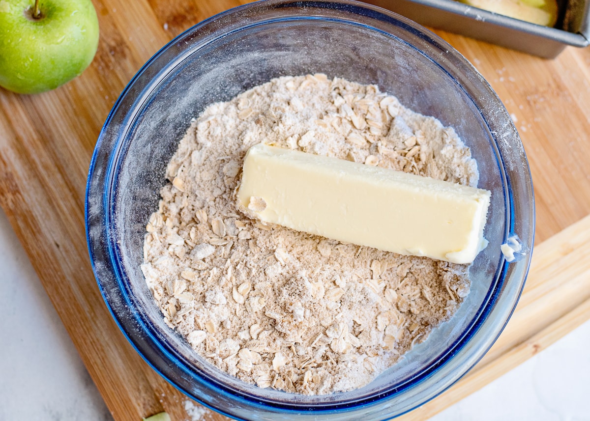 a stick of butter with crisp ingredients in a bowl.