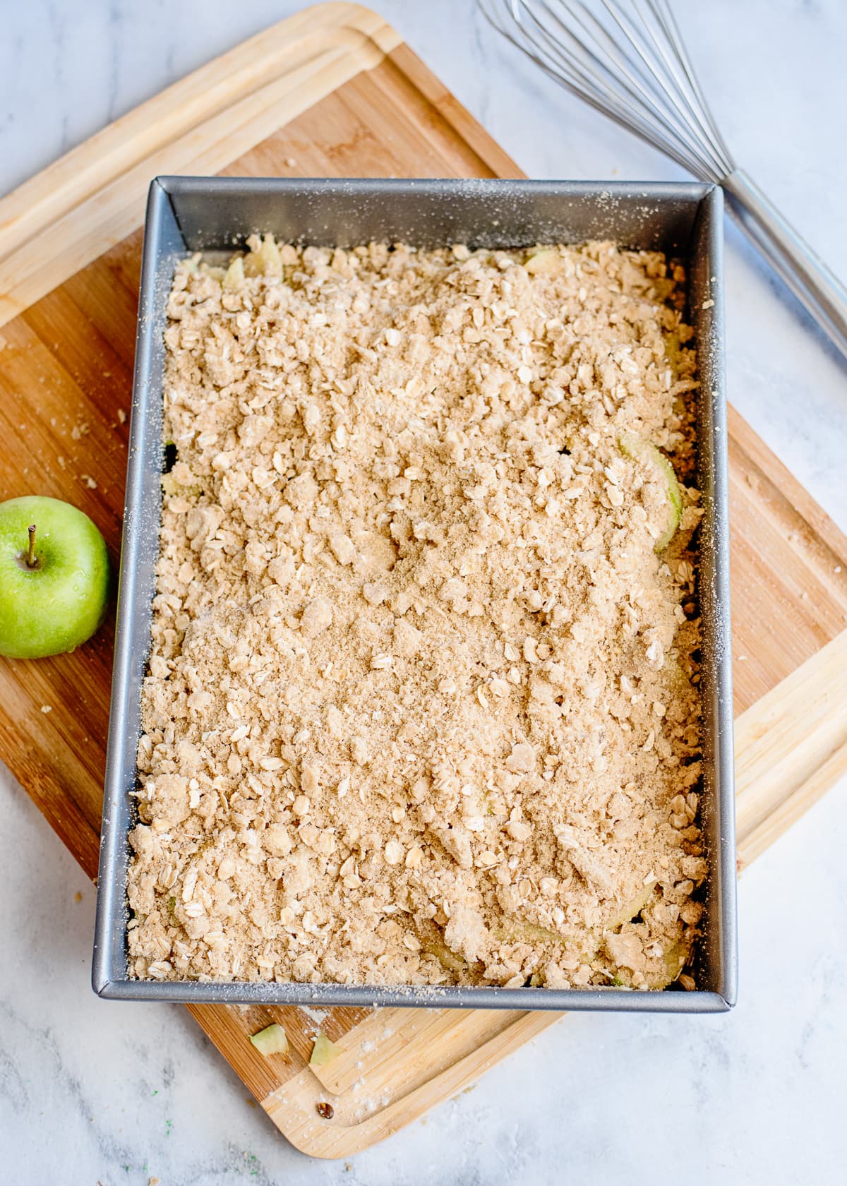 uncooked apple crisp in a baking dish.