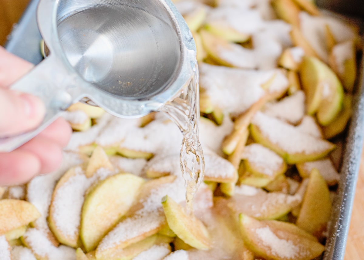 pouring water over cinnamon sugared apples.