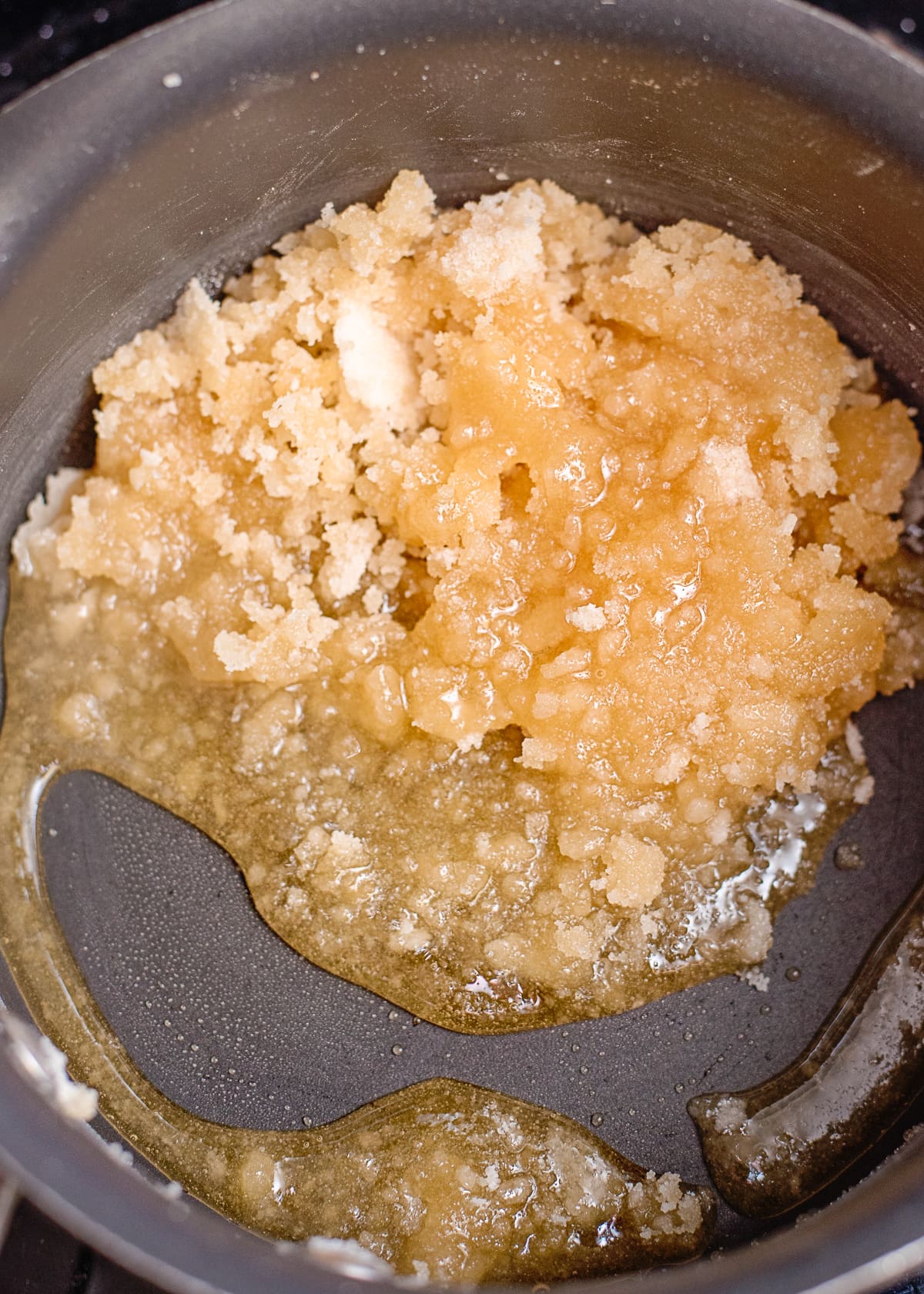 sugars melting in a saucepan to make caramel.
