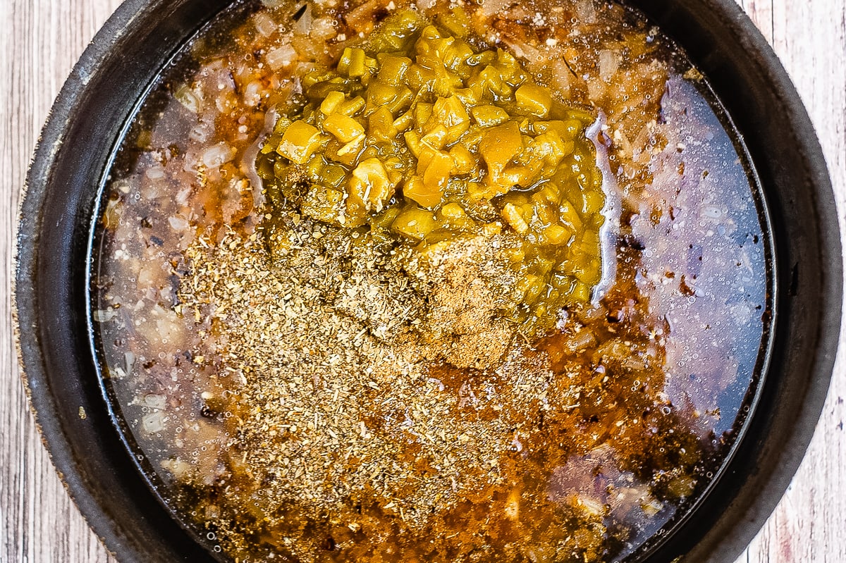 ingredients for enchilada sauce in a pan.